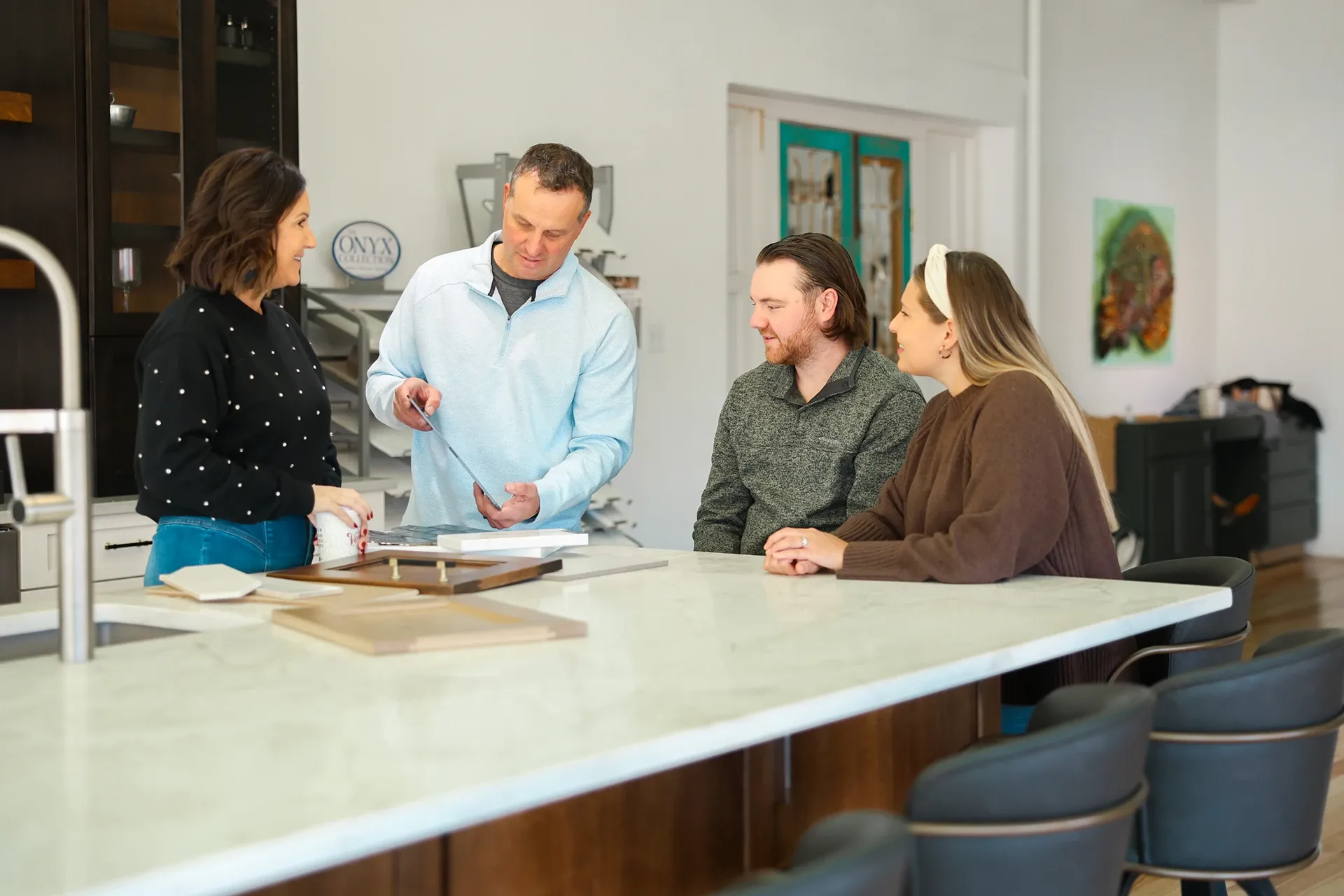 A 3 Day Kitchen & Bath designer reviewing plans with homeowners at their kitchen table