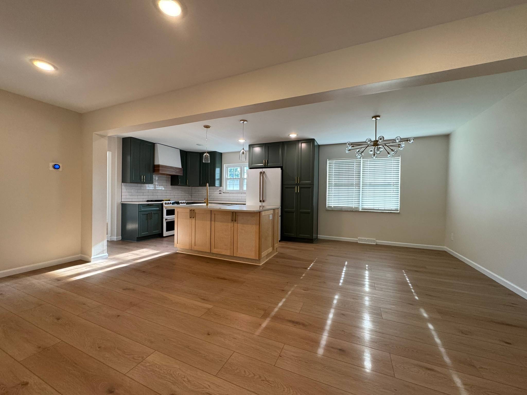 Forest green shaker kitchen with maple island