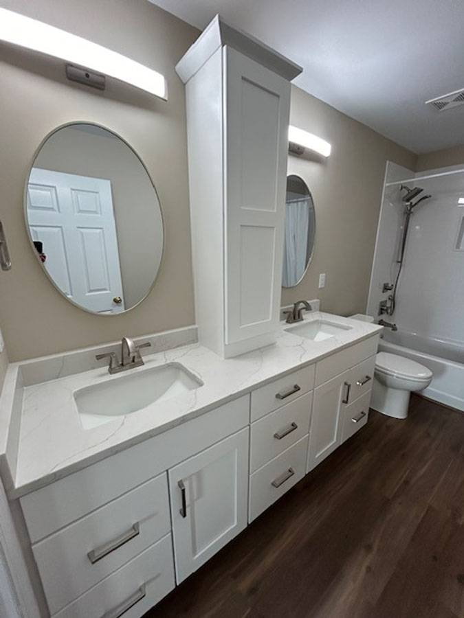 White double vanity with a center storage tower